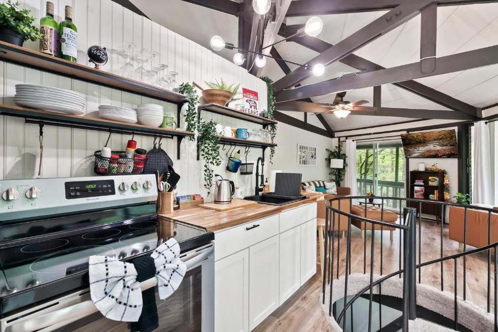 a kitchen with white cabinets and a stove at Bear Whispers in Townsend