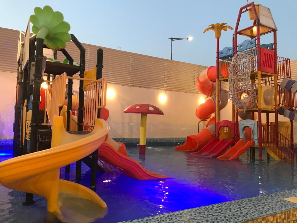 a water park with a slide and a playground at شاليهات رانديفو العاب مائية مع مسبح in Riyadh