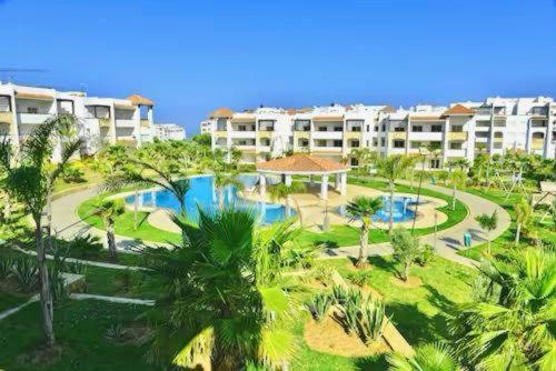 an aerial view of a resort with a swimming pool at Prestigieux Appartement à Marina Assilah Golf in Asilah