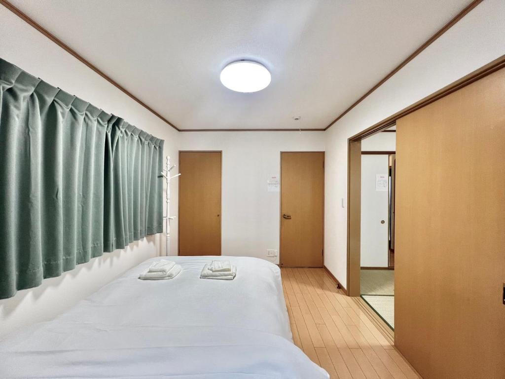Postel nebo postele na pokoji v ubytování AX-Asaka House