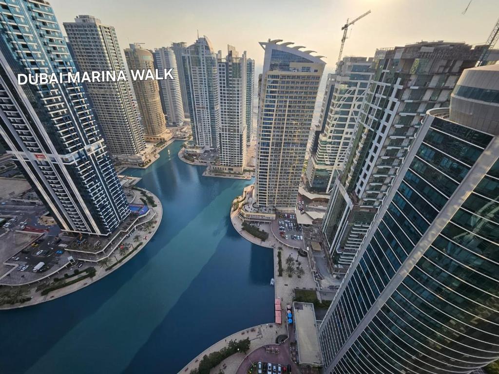 a view of a river in a city with tall buildings at Stunning 1Bedroom Apartment - With Amazing Dubai Marina View in Dubai