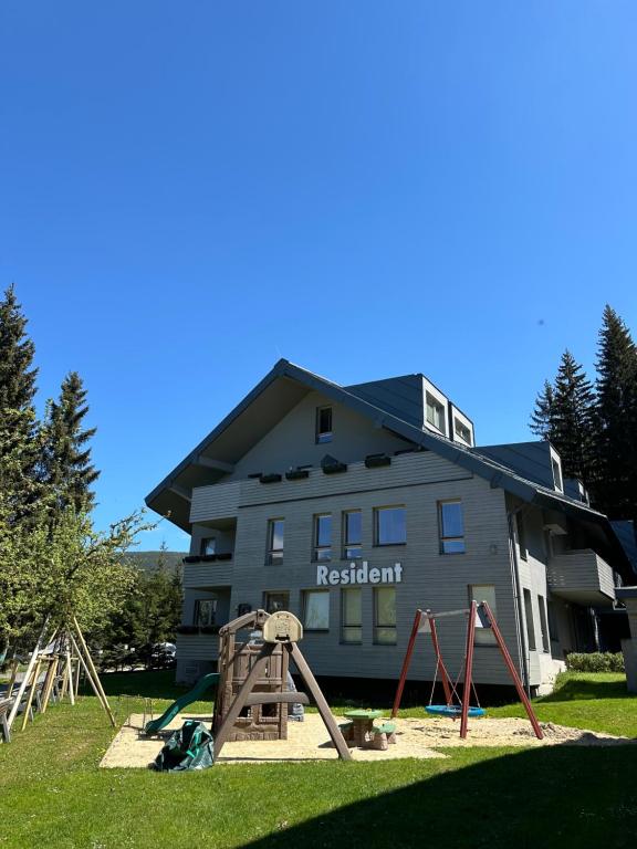 a playground in front of a residential building at Apartment Katrin Harrachov Resident - Sauna world free in Harrachov
