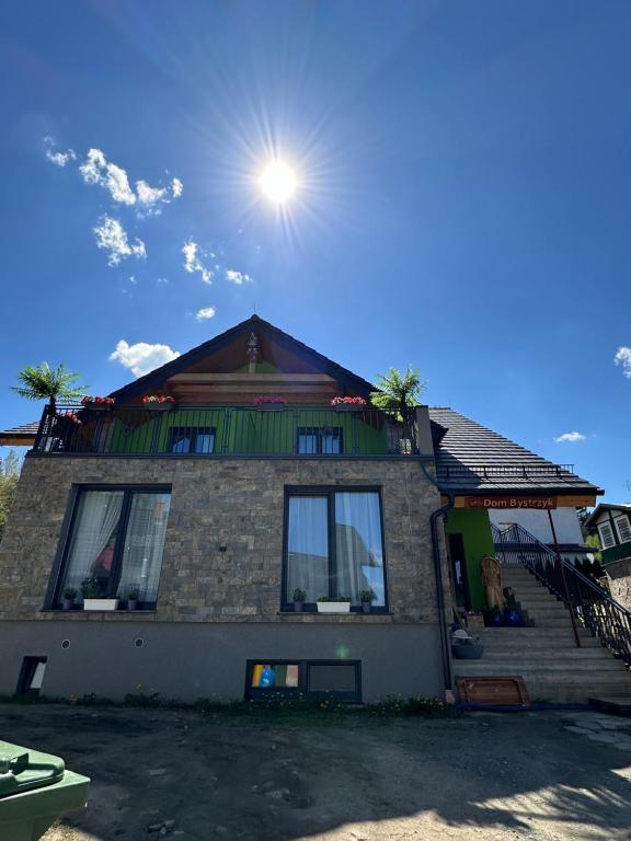 a house with the sun on top of it at Dom Bystrzyk in Karpacz