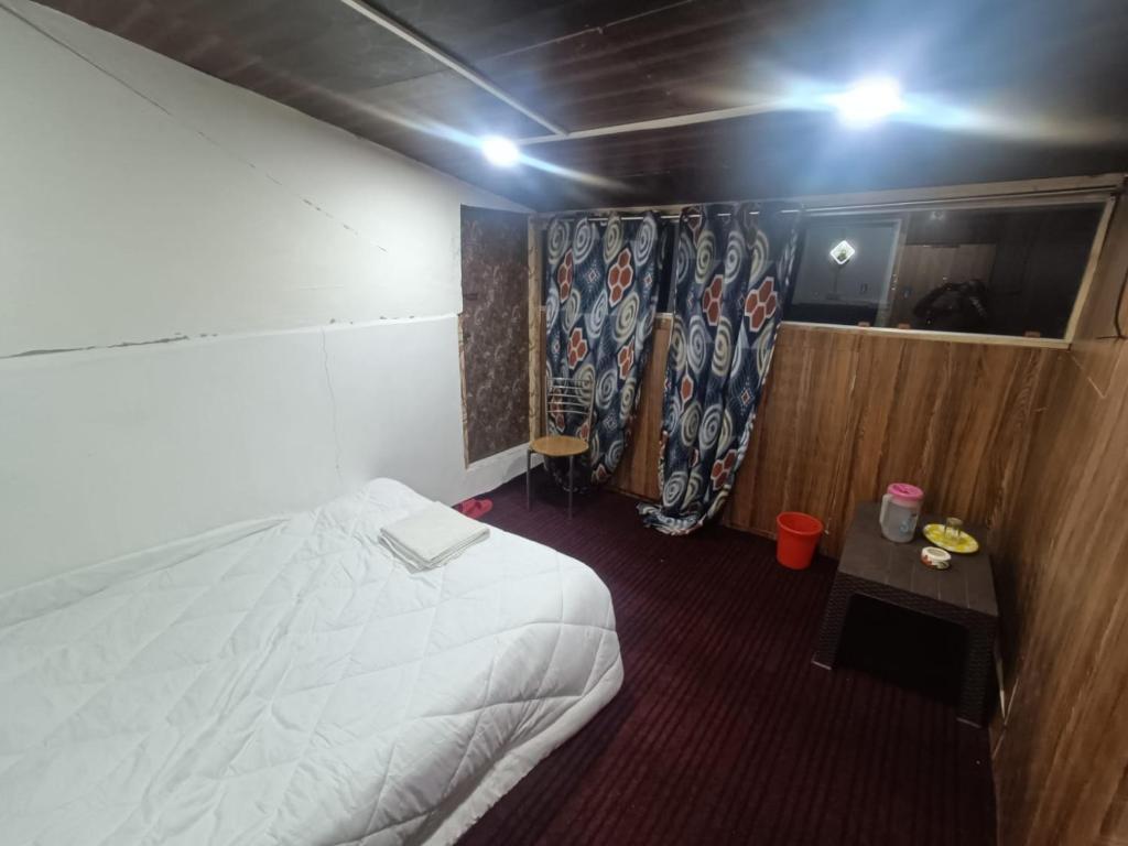 Postel nebo postele na pokoji v ubytování Hotel New Heaven Canal