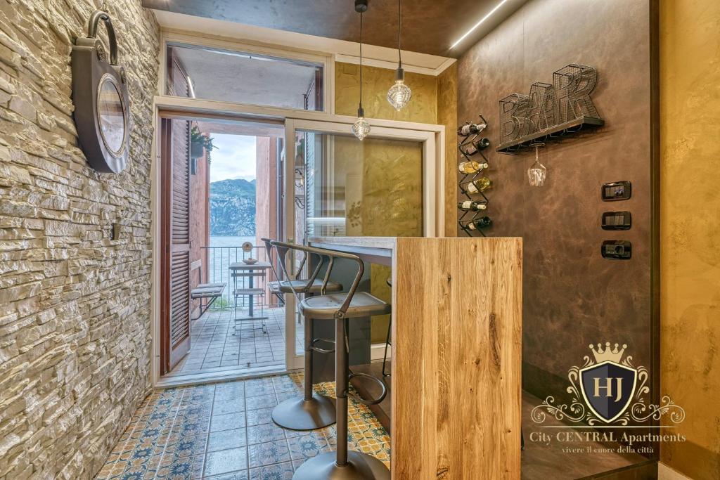 a bar in a home with a stone wall at City CENTRAL Apartment Romantic Lakefront Balcony - MALCESINE - Porto Vecchio 11 in Malcesine