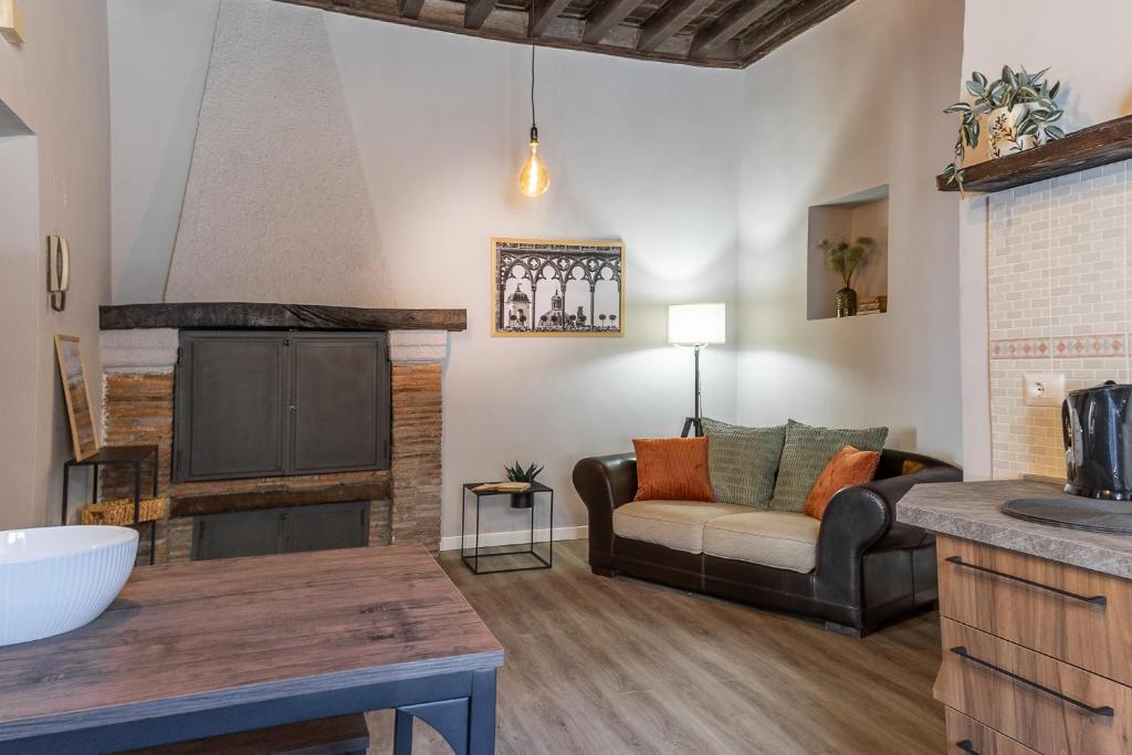 Una sala de estar con un sofá y una chimenea. en L'Alloggio di San Pellegrino, en Viterbo