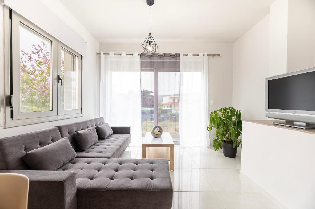 a living room with a couch and a tv at HyperCenter Diamond in Kos Town