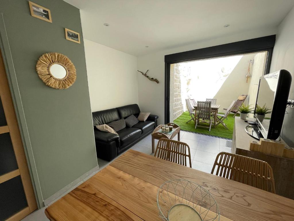 a living room with a couch and a table at Whalecome Camargue in Aigues-Mortes