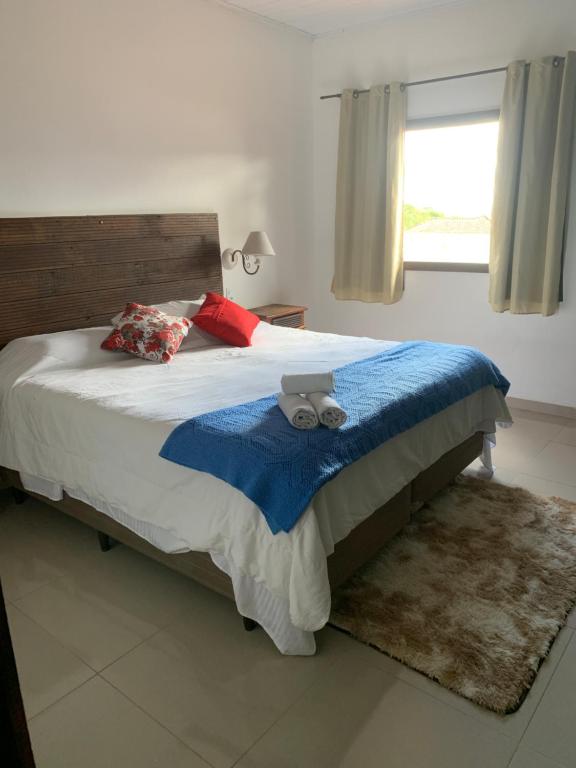 um quarto com uma cama com um ursinho de pelúcia em Hospedagem vicentina em Tiradentes