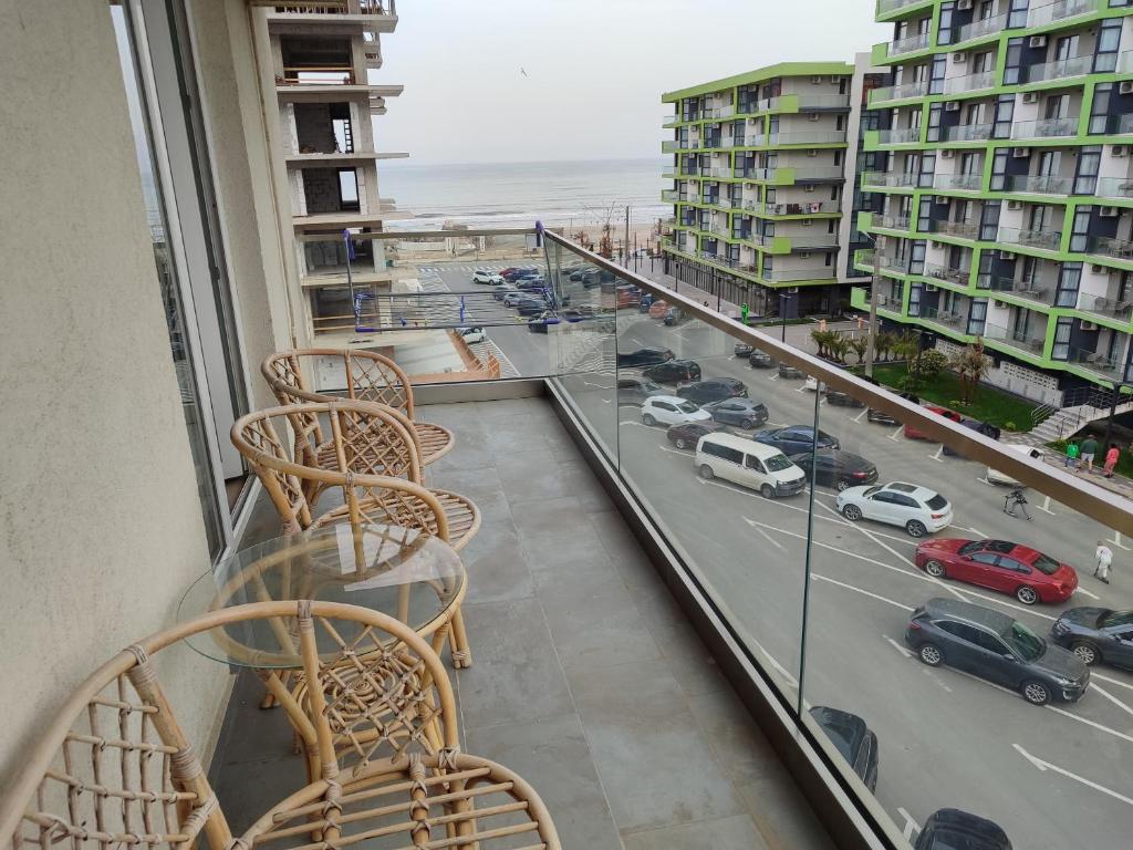 a balcony with chairs and a view of a highway at Nord Residence in Mamaia Nord