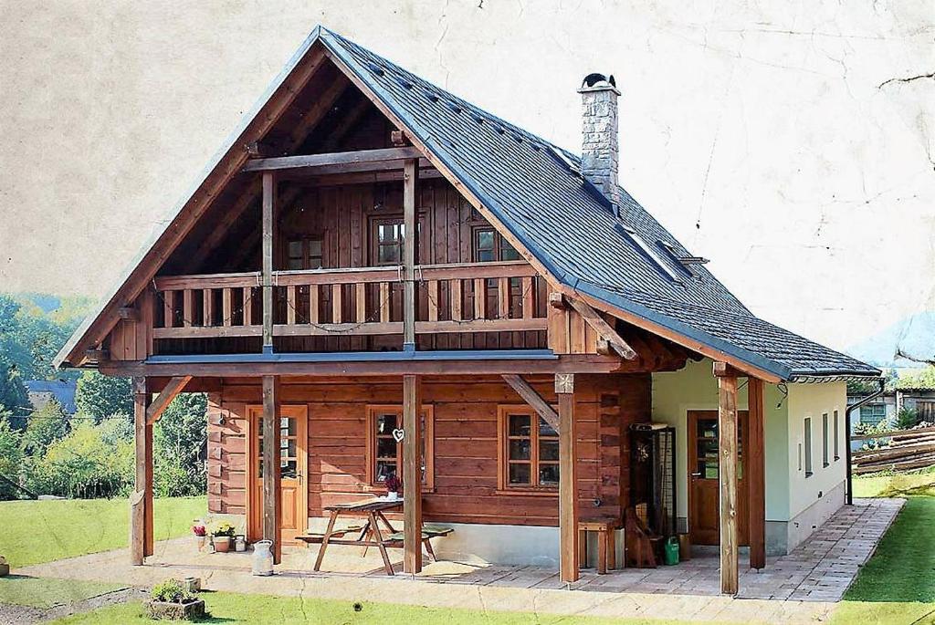 a large wooden house with a gambrel roof at U Rozlitýho mlíka in Chvaleč