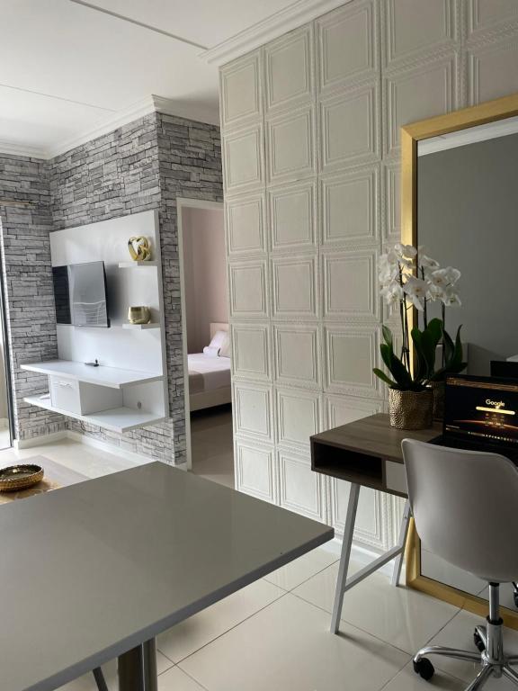 a room with a table and a mirror and a bedroom at Classy 2 bedroom in Halfway Gardens in Midrand