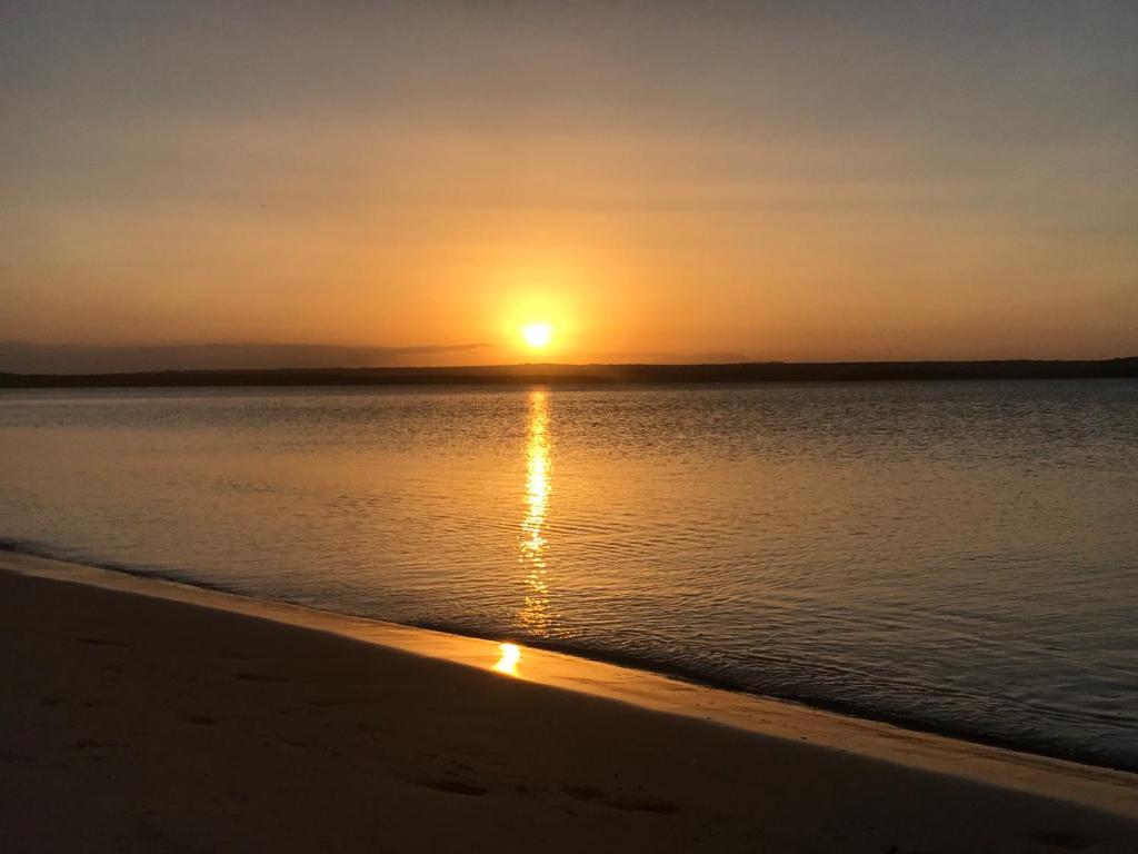un tramonto sulla spiaggia con il tramonto di Paraíso na Barra a Rio Tinto