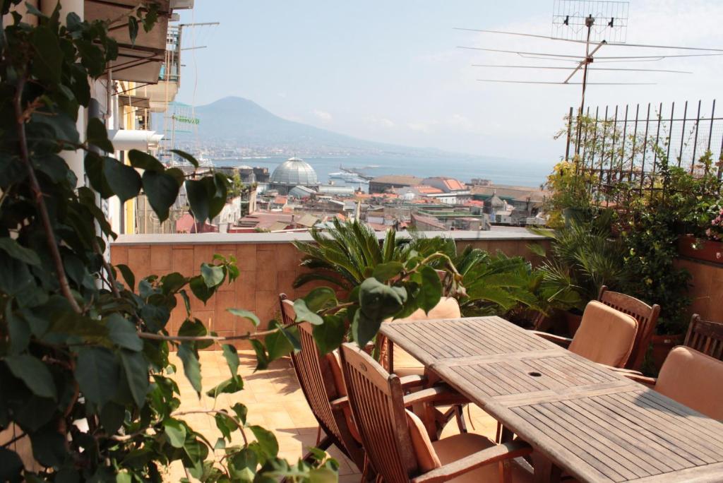 a table and chairs on a balcony with a view at Smile At Vesuvio in Naples