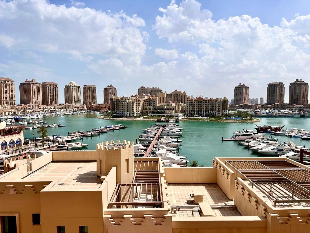a view of a harbor with boats in the water at Alken Studio - Amazing Superior Studio with Marvellous Marina View in the Pearl, Doha in Doha