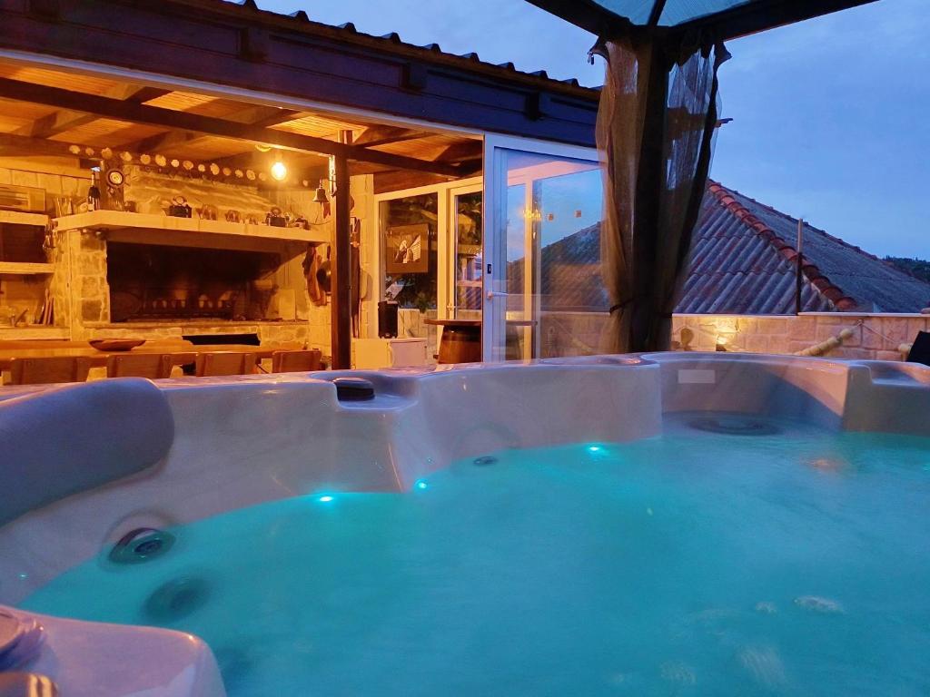 a jacuzzi tub in front of a house at Luxury Sunrise Jacuzzi Apts, 50 m from the beach in Kali