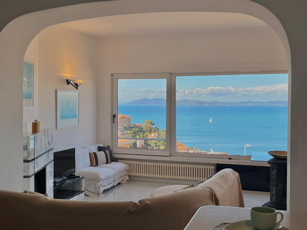 a living room with a view of the ocean at [porto santo stefano] vista mare + parcheggio gratuito in Porto Santo Stefano