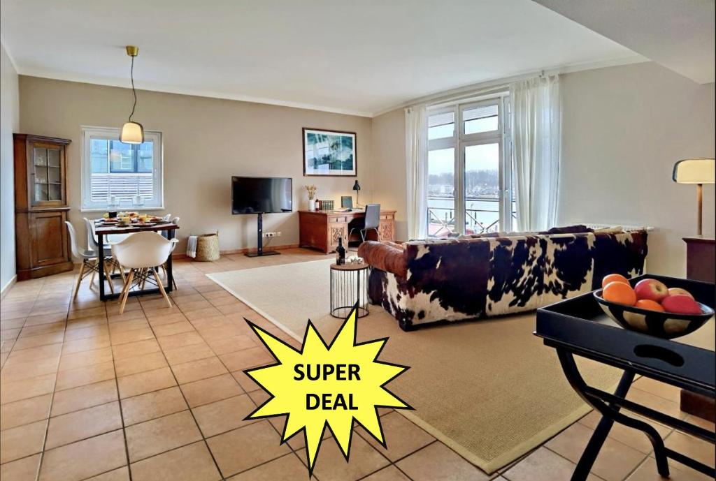 a living room with a super deal sign on the floor at Penthouse Marina - Sauna und Flussblick in Travemünde