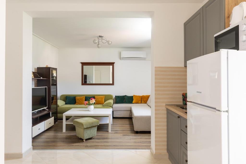 a living room with a couch and a table at Stephanie green island apartments in Šipanska Luka