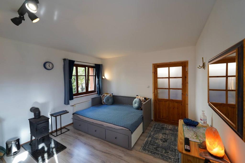 a bedroom with a blue bed in a room at Garsonka u pivovaru, centrum Rožnov in Rožnov pod Radhoštěm