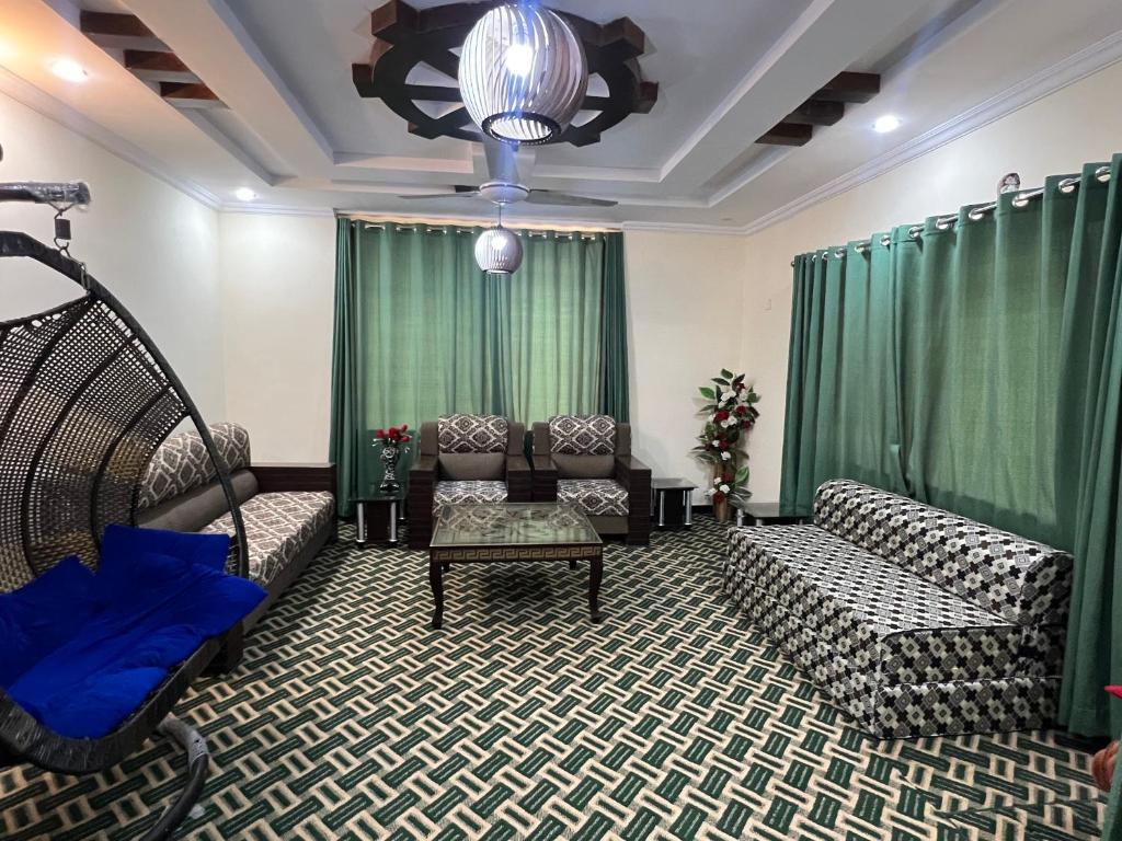 a living room with couches and a chandelier at Home in Islamabad in Islamabad
