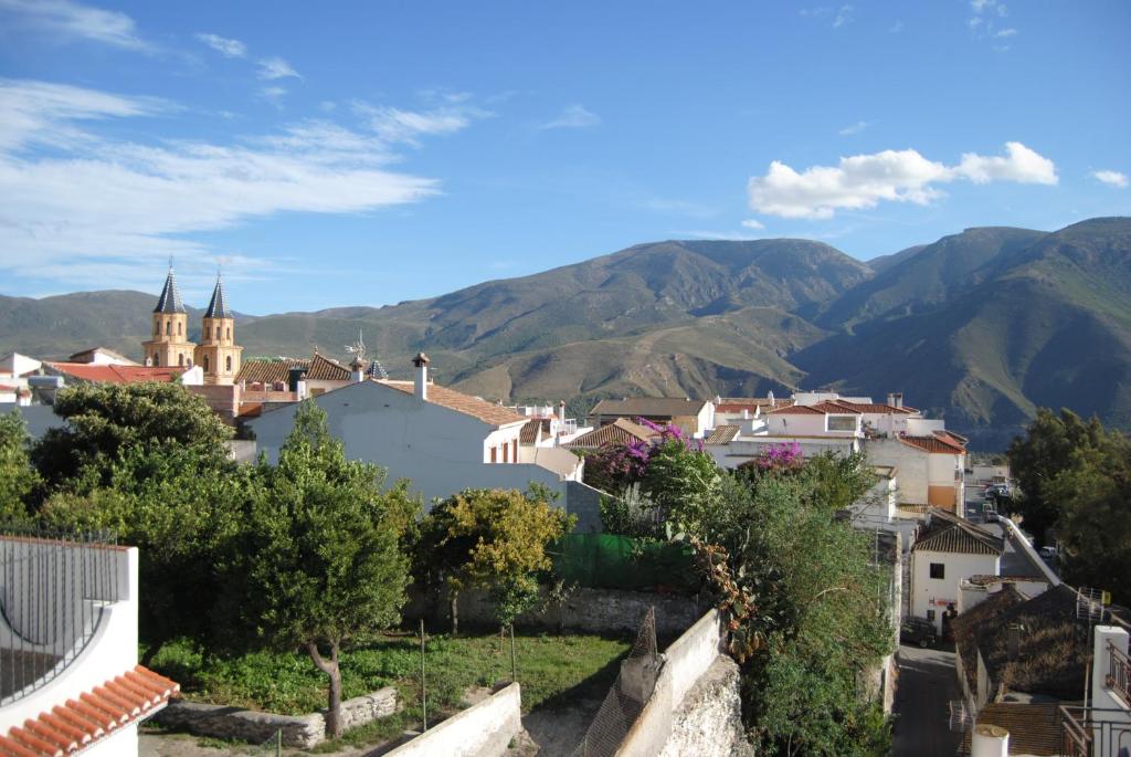 a view of a town with mountains in the background at Hotel Mirasol in Órgiva