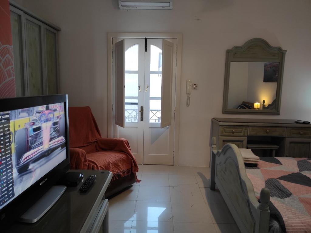 a living room with a television and a couch at Ta' Marija Home in Sliema