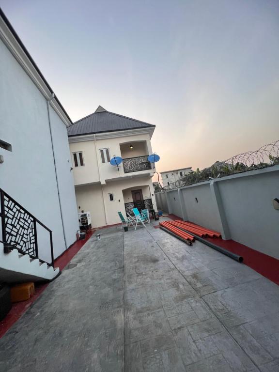 an empty balcony of a building with two chairs at Apartments by Dee in Port Harcourt