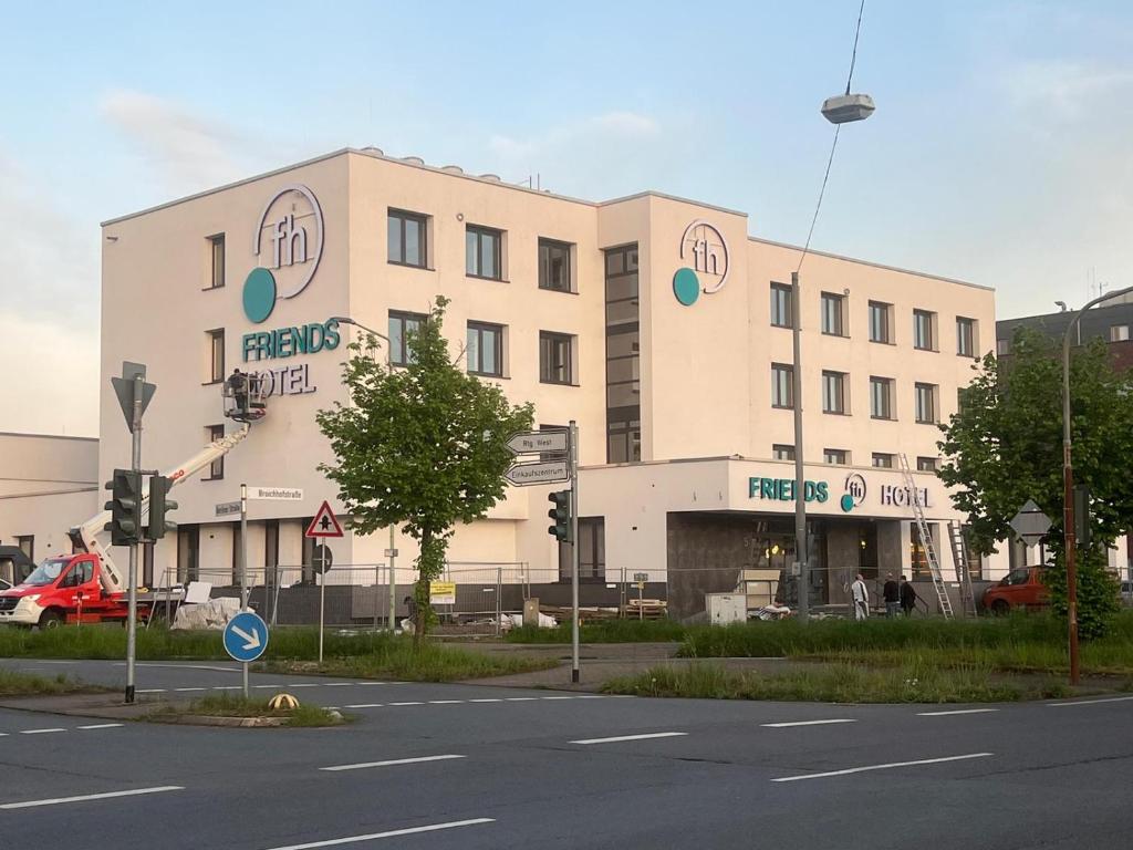 a large building on the corner of a street at Friends Hotel Düsseldorf-Airport Ratingen in Ratingen