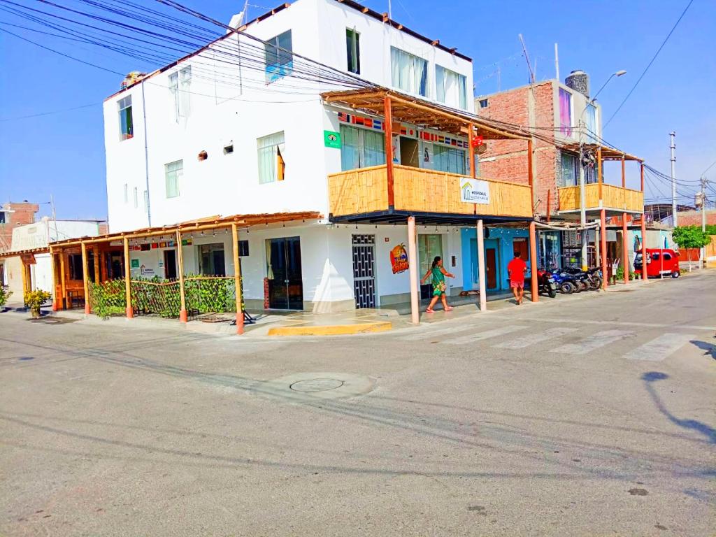 帕拉卡斯的住宿－HOSPEDAJE WELCOME paracas，一条空的街道,在拐角处有一座白色的建筑