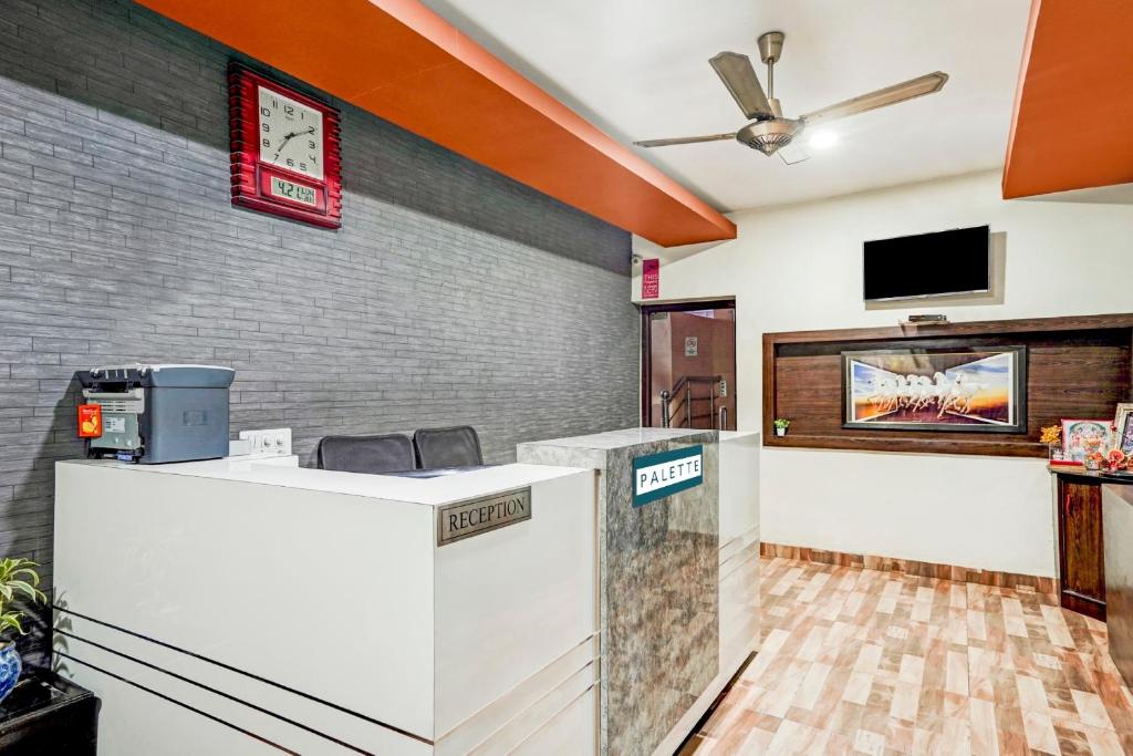 a lobby with a reception desk and a tv at Palette - JPS Residency in Gurgaon