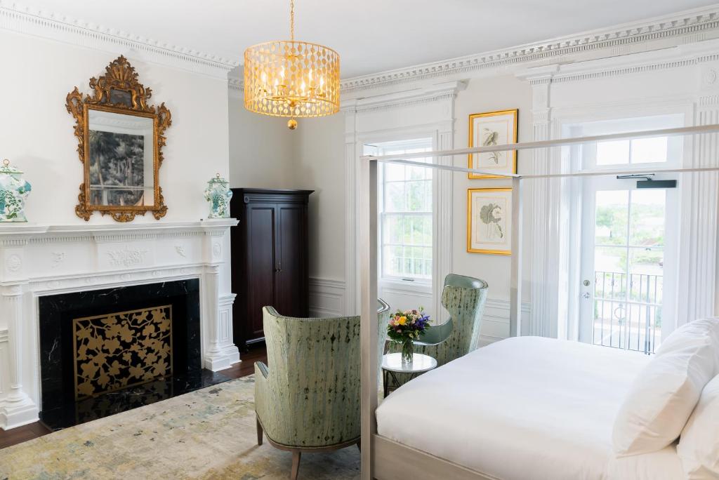 a bedroom with a bed and a fireplace at The Harvey in New Bern