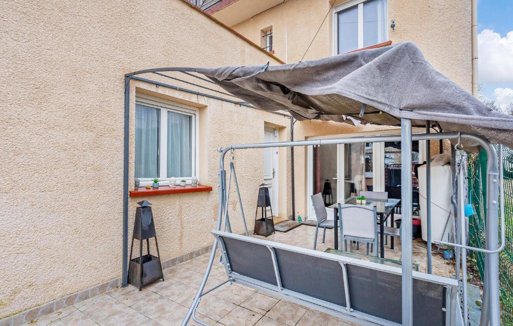 a patio with an umbrella on a balcony at Cozy Apartment In St Thibault Des Vignes With Kitchenette in Saint-Thibault-des-Vignes