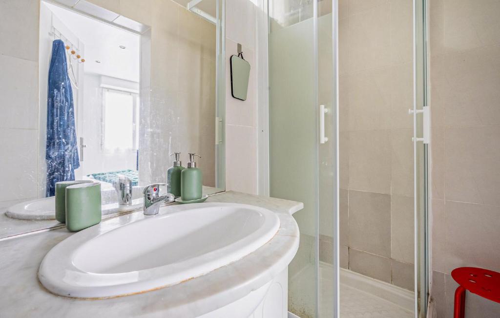 a bathroom with a sink and a glass shower at Cozy Apartment In St Thibault Des Vignes With Kitchenette in Saint-Thibault-des-Vignes