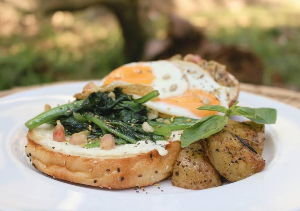 a plate of food with an egg and potatoes at Calma - Surf, Yoga & Coffee on a Private Beach in Dickwella