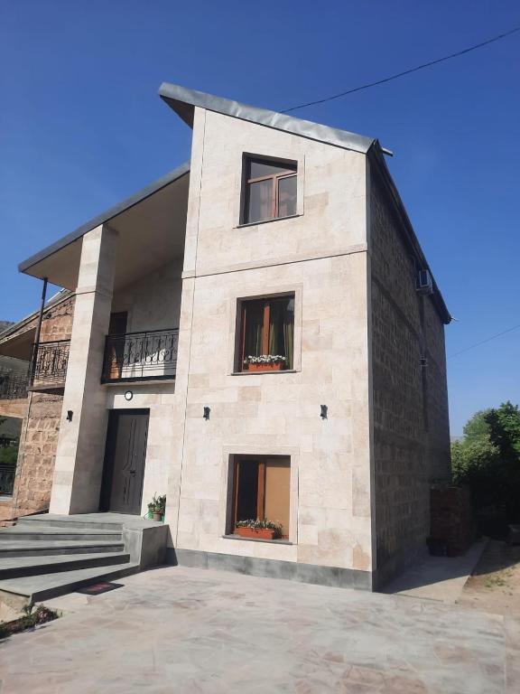 a large brick building with two windows and stairs at Anna Home B&B in Areni