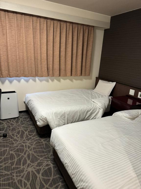 Postel nebo postele na pokoji v ubytování Hotel Silk Tree Nagoya