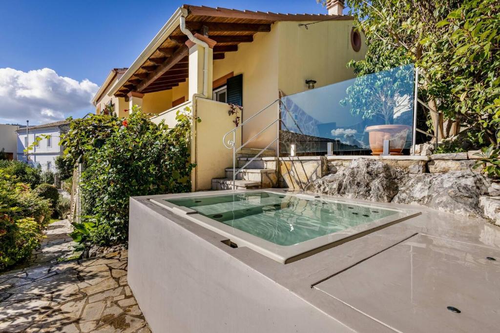 a hot tub in the backyard of a house at Villa Edem in Kassiopi