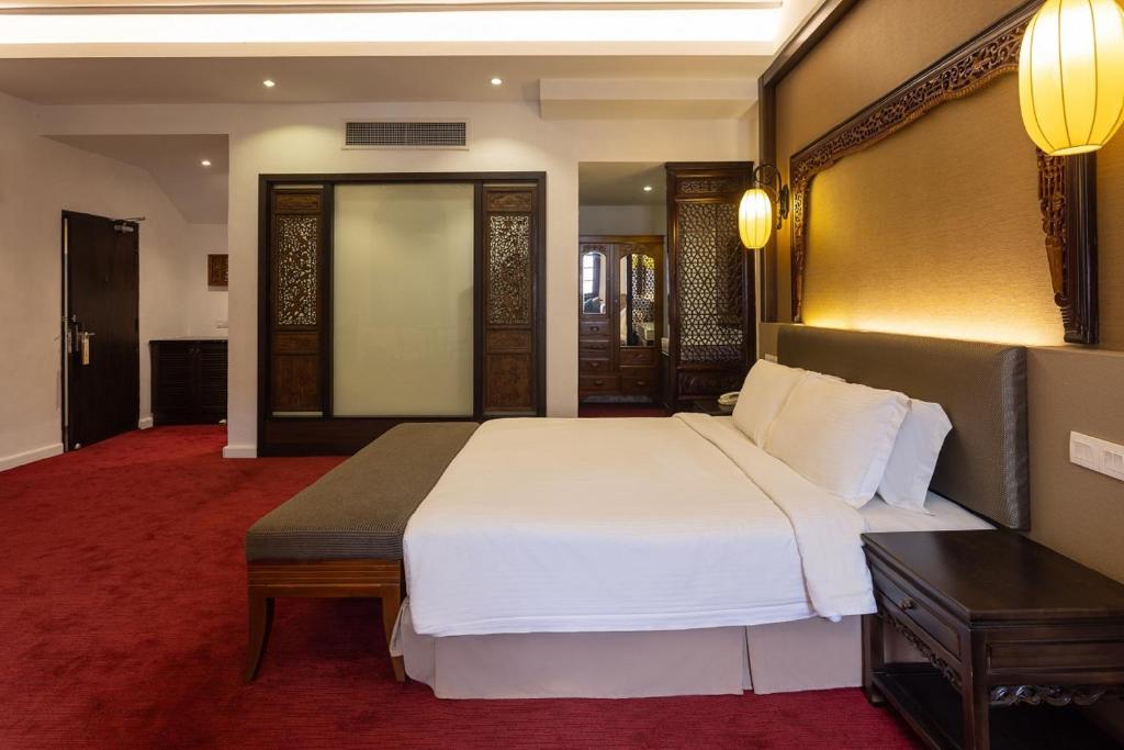 Postel nebo postele na pokoji v ubytování Hotel Puri Melaka