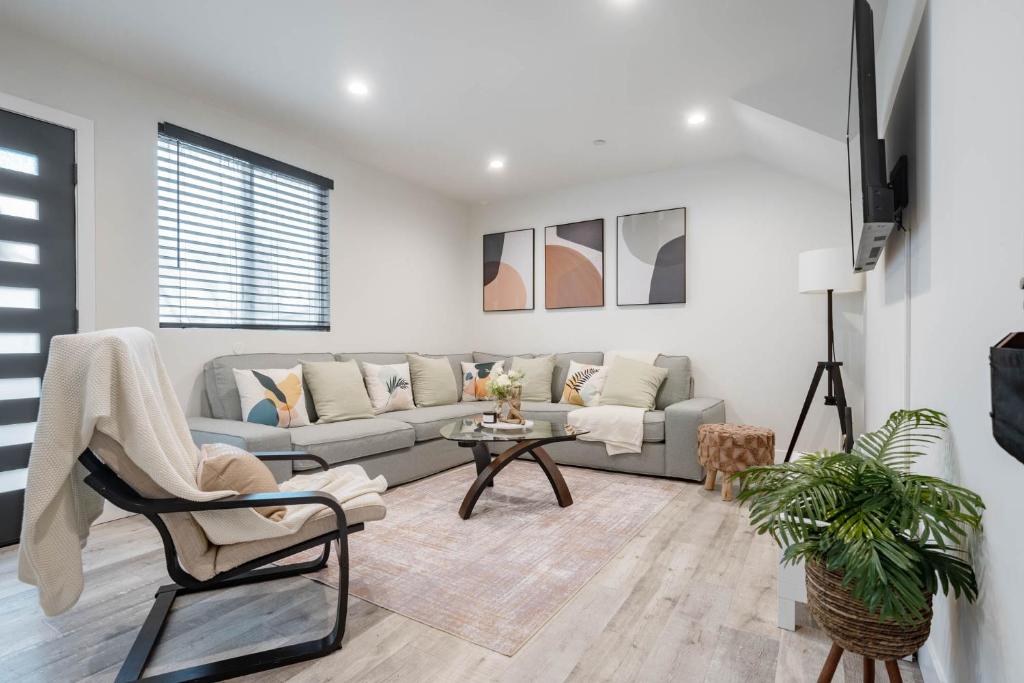 a living room with a couch and a table at Modern NOHO Gem! in Los Angeles