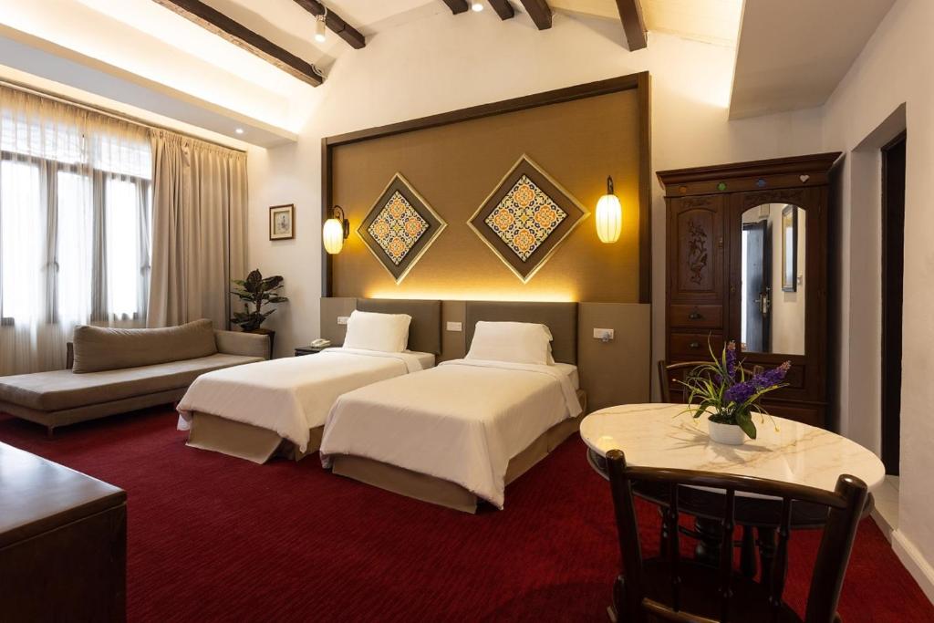 Postel nebo postele na pokoji v ubytování Hotel Puri Melaka