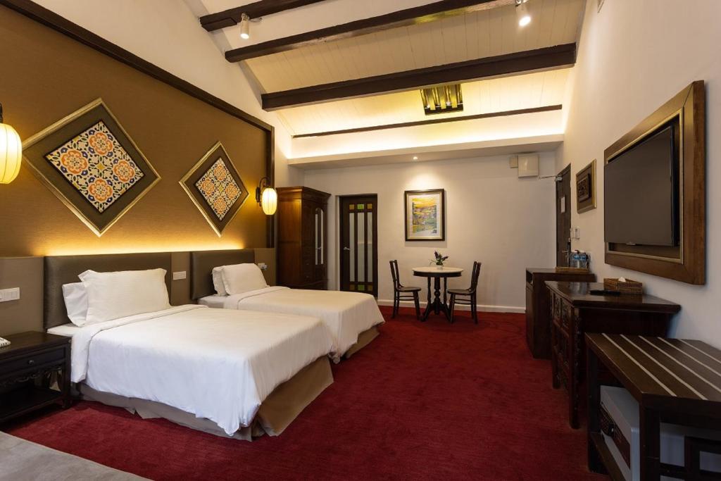 Postel nebo postele na pokoji v ubytování Hotel Puri Melaka