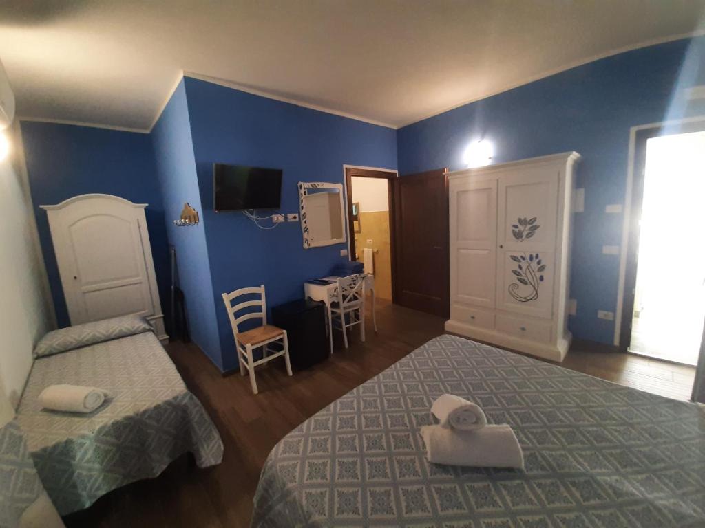 Postel nebo postele na pokoji v ubytování Borgo Rurale Cares