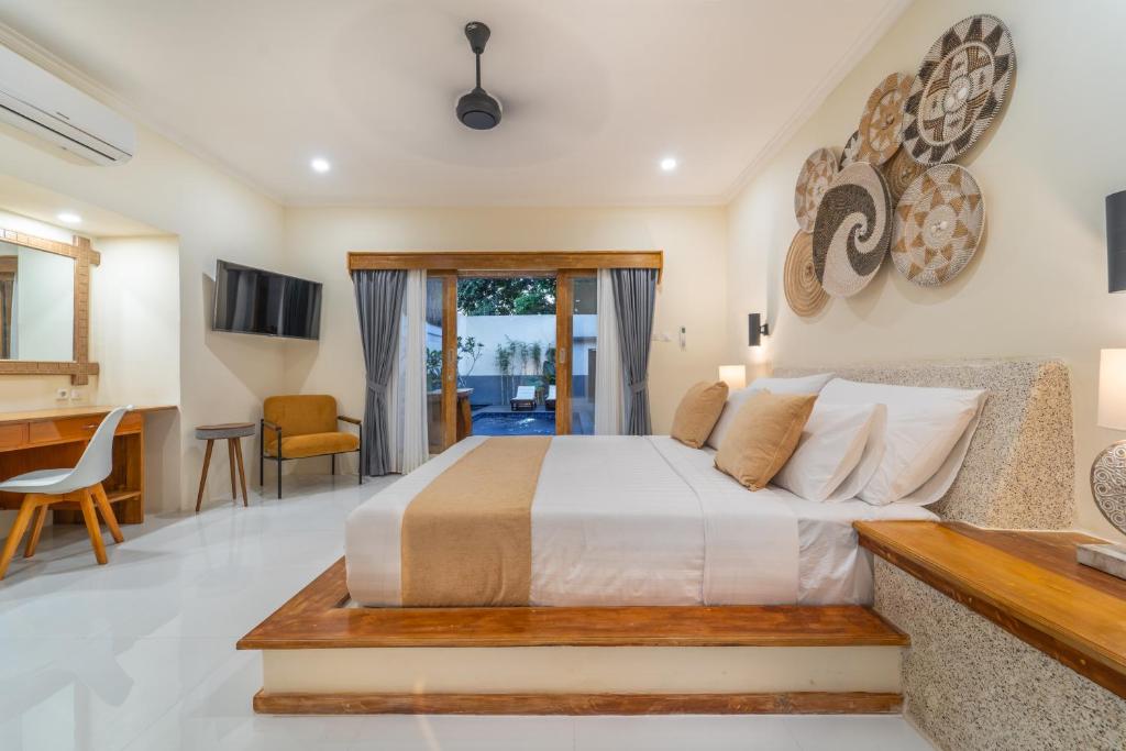 a bedroom with a bed and a living room at Tanis Village - Luxury Villas in Gili Air