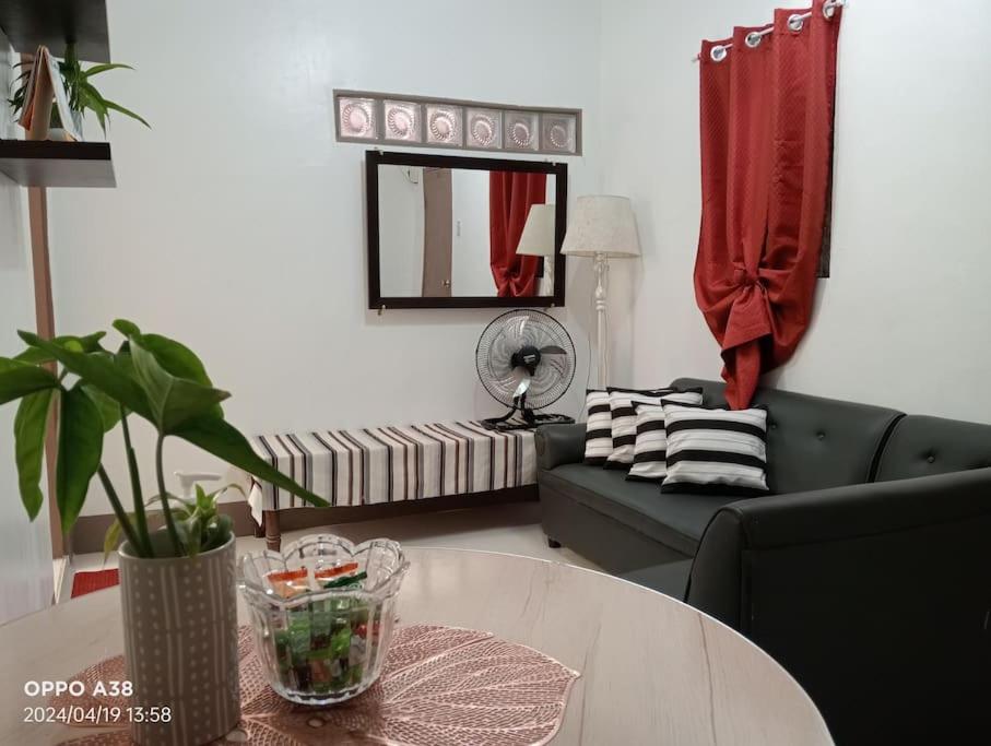 a living room with a couch and a table at RY Nest in Malaybalay