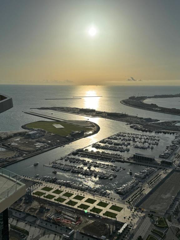 an aerial view of a marina with the sun setting at Stunning 1 BR Apartment in Dubai Marina in Dubai