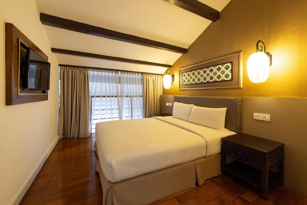 Postel nebo postele na pokoji v ubytování Hotel Puri Melaka