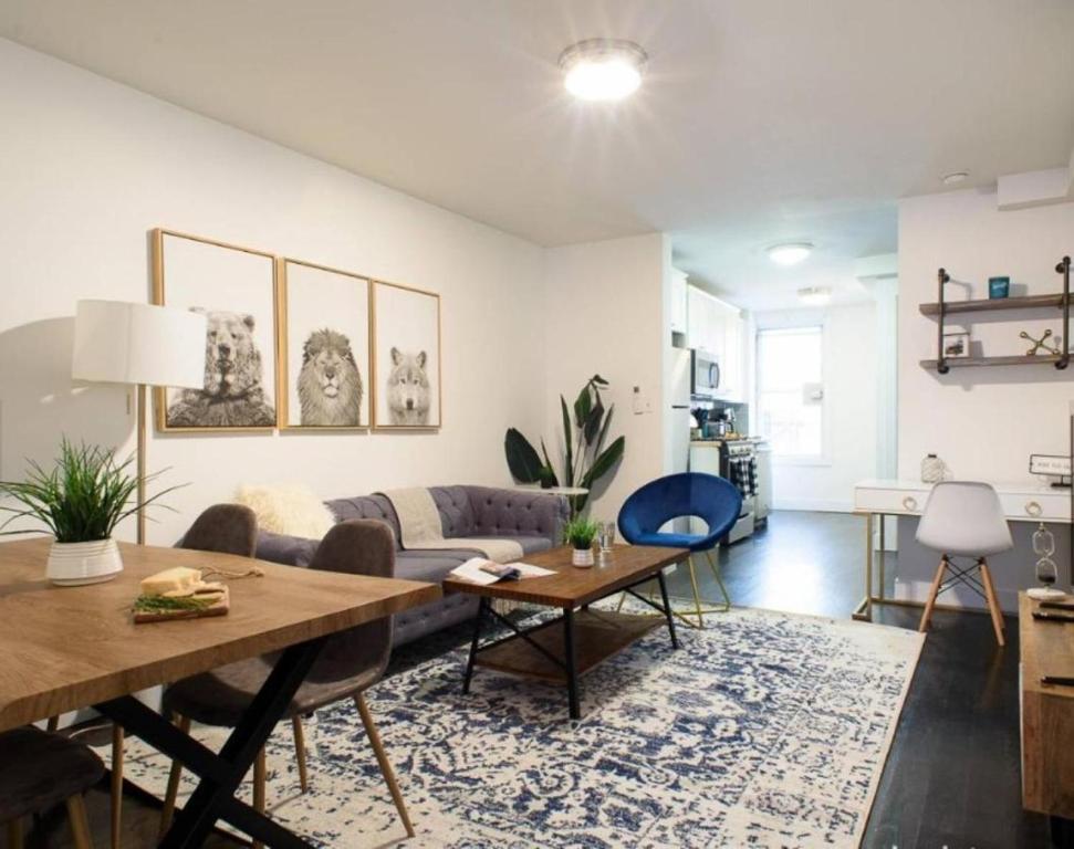 a living room with a table and a couch at Lovely 4 BR in NYC! in New York