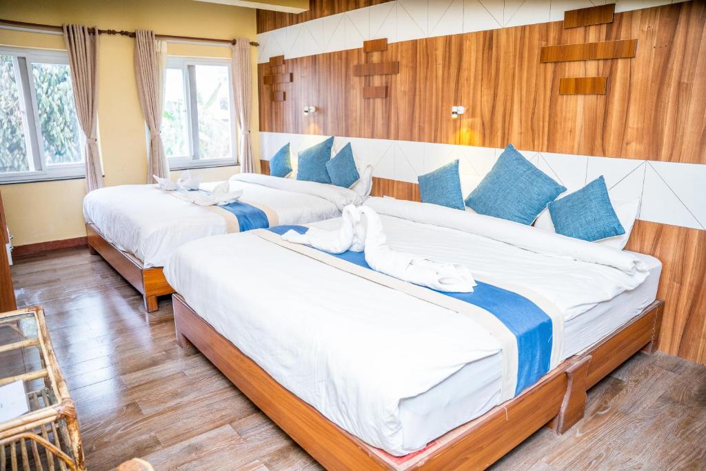 Llit o llits en una habitació de Hotel Glory Garden