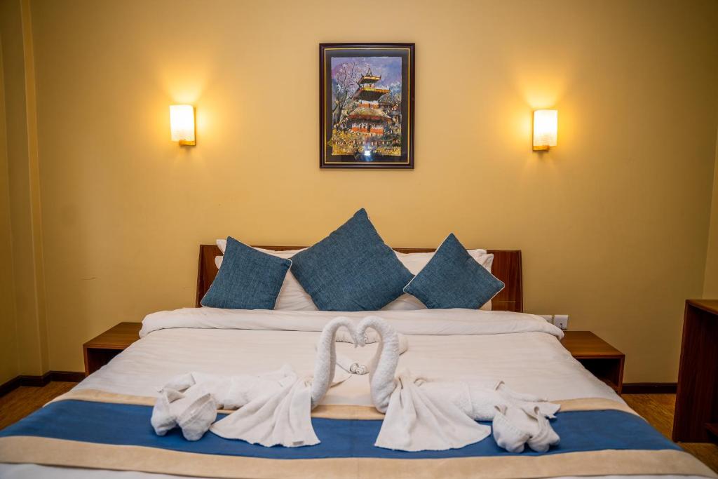 Llit o llits en una habitació de Hotel Glory Garden